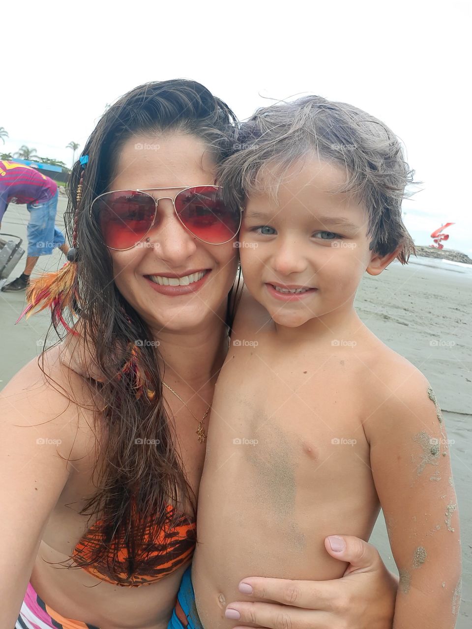smiling woman and son on the beach in Santos