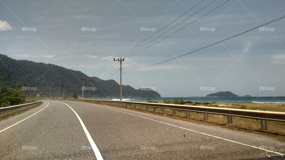 Highway beside the beach and mountains