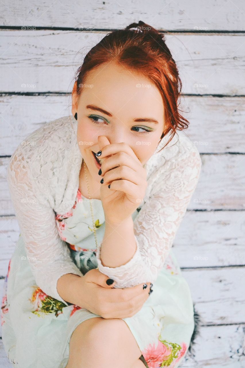 Smiling woman sitting on wooden bench