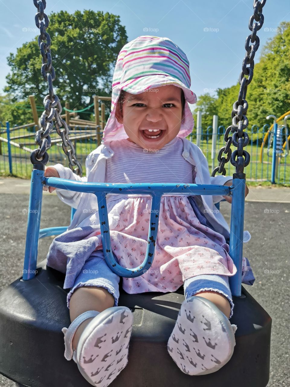 Happy smiling teeth baby in swing
