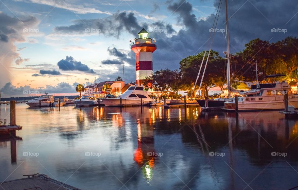 A lighthouse that stands above all else surrounding it shows the way home for on coming boats