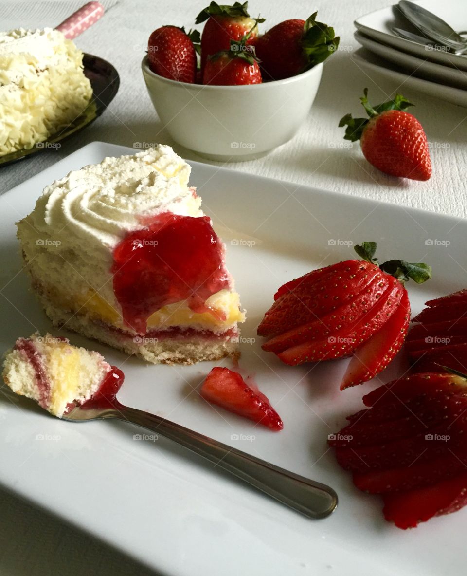 Having a slice of Freshcream cake and strawberries 