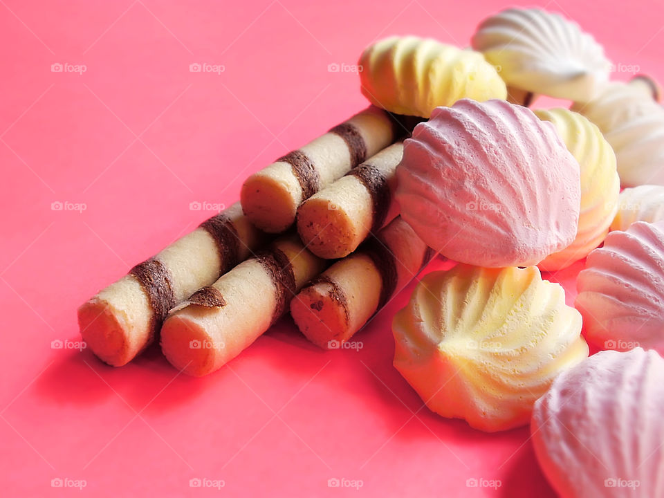 Colorful pastel candies on pink pastel background 
