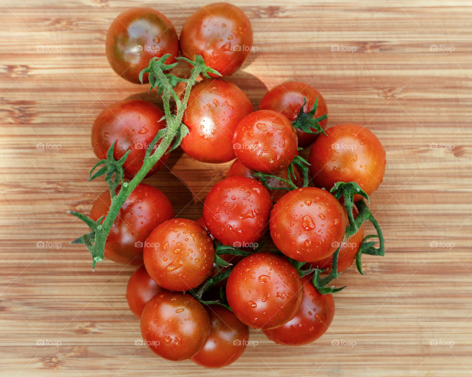 food background of fresh small tomatoes on wood table