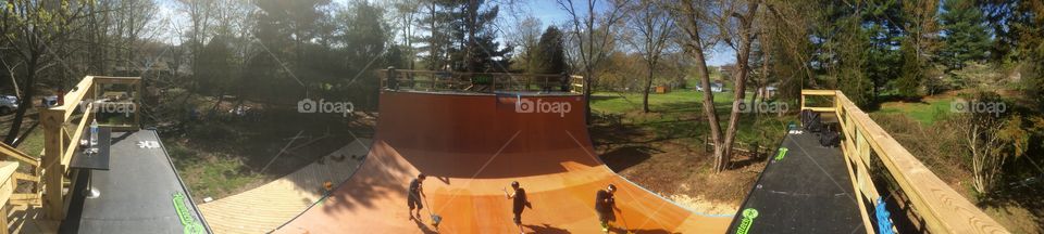 Panoramic photo of a skateboard very ramp on a fall afternoon 