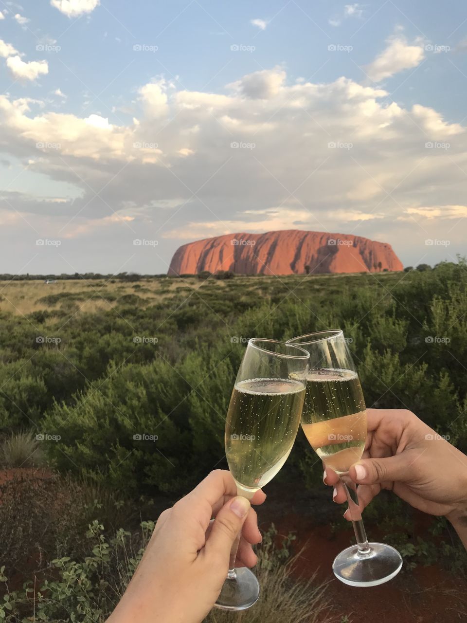 Cheers to the Outback. A champagne toast at sunset at Ayers Rock/Uluru in the Australian Outback.