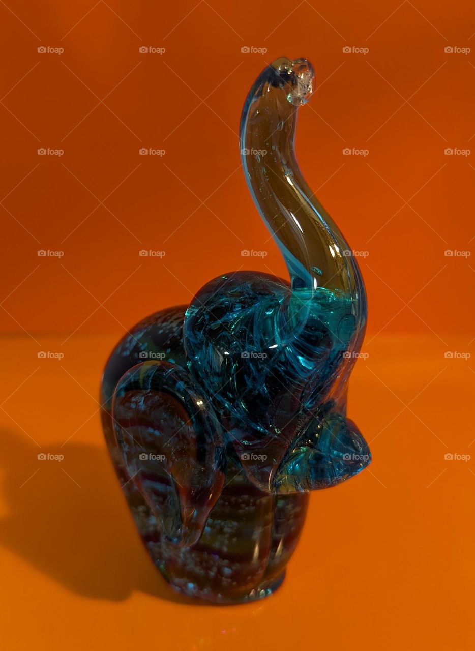 Blue elephant with orange background