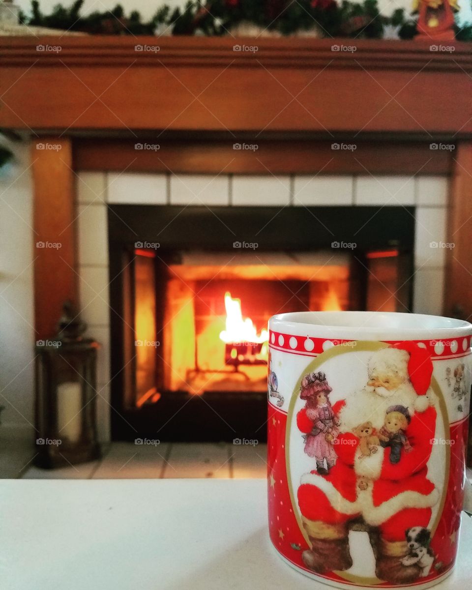 cozy by the fire with a warm mug of hot chocolate