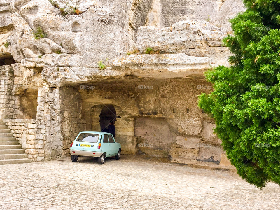 Cute tiny car parked in garage carved from the rock