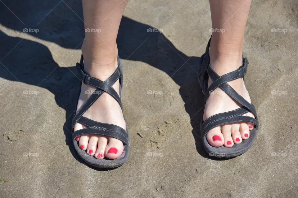 Woman’s feet in the sand of a beach 