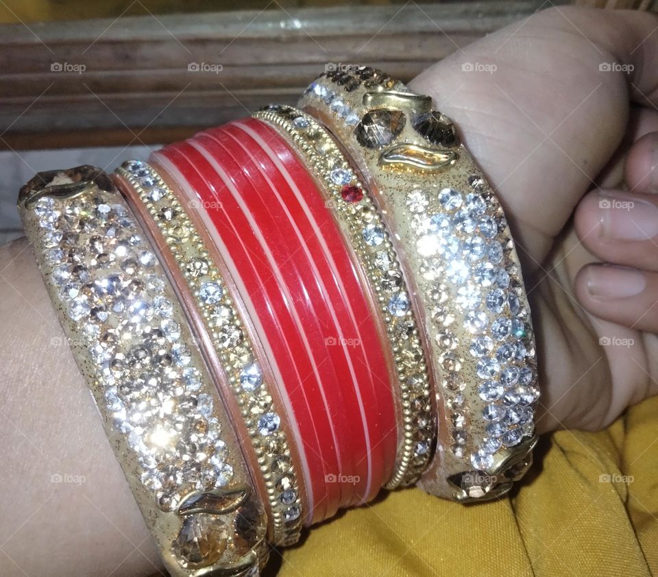 Indian women wear bangles in their hands .