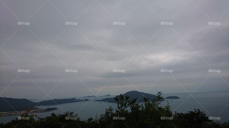 ocean, island, and cloudy sky