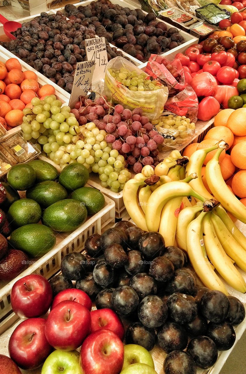 Market with various colorful fresh fruits and vegetables