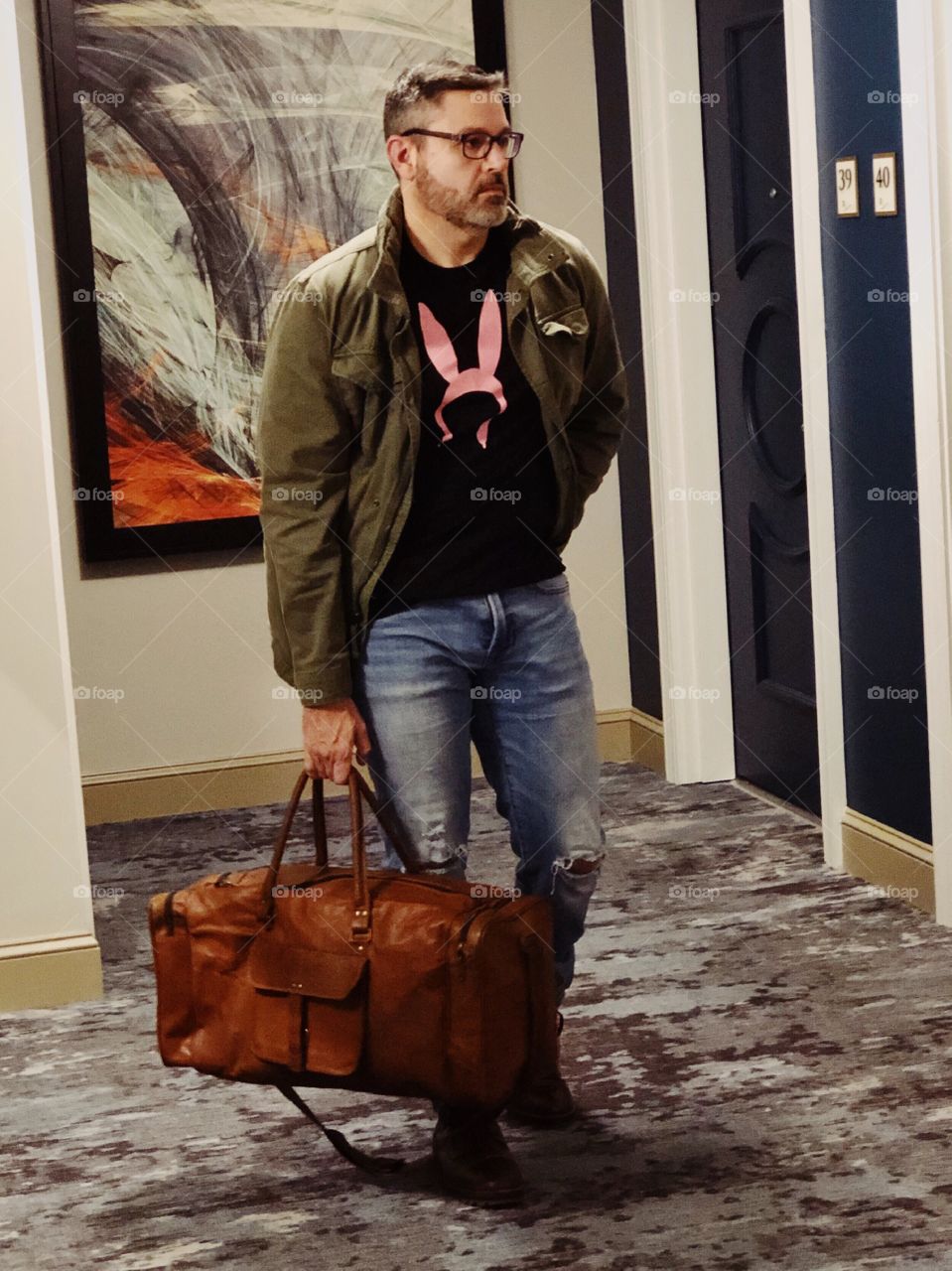 Bearded man traveling with leather suitcase 