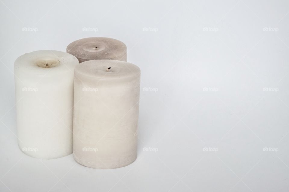 Candles stone color on white background 