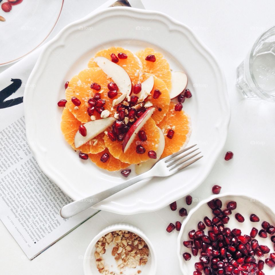 Healthy meal. Orange, apple and pomegranate with almond salad for healthy meal