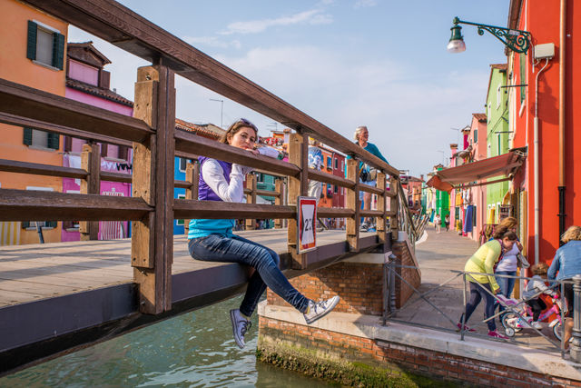 Woman on bridge over canal in the city