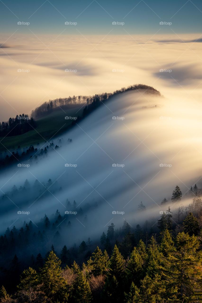 A beautiful cloud sea flows over a mountain 