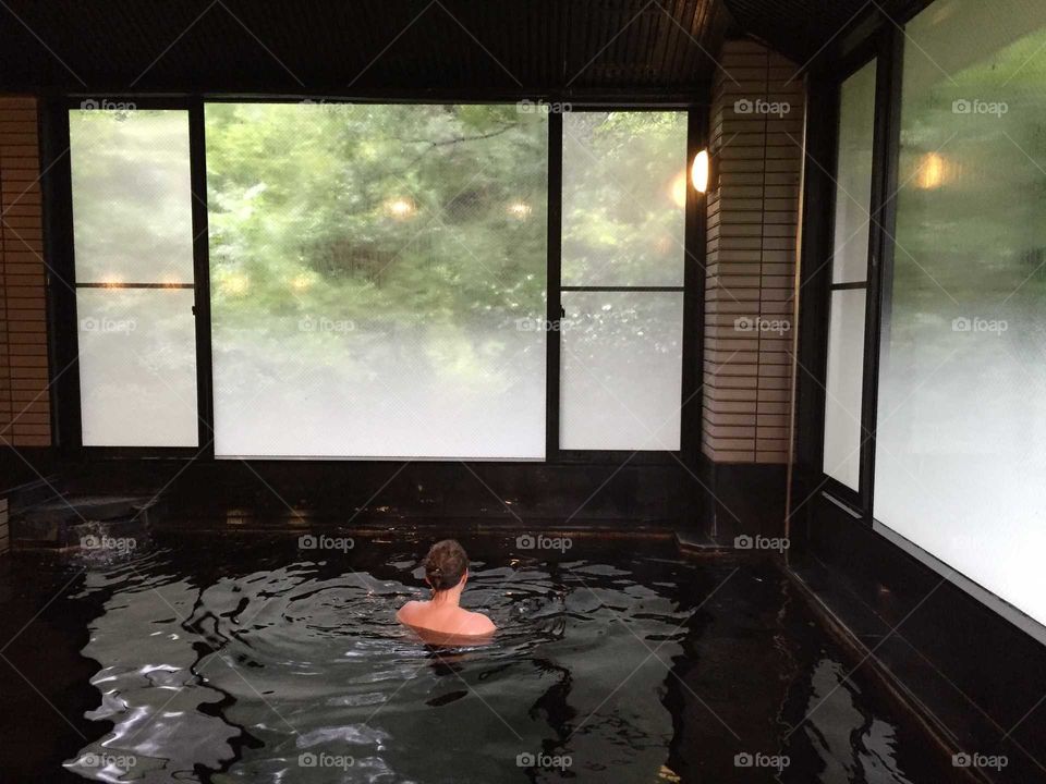A girl in black water onsen