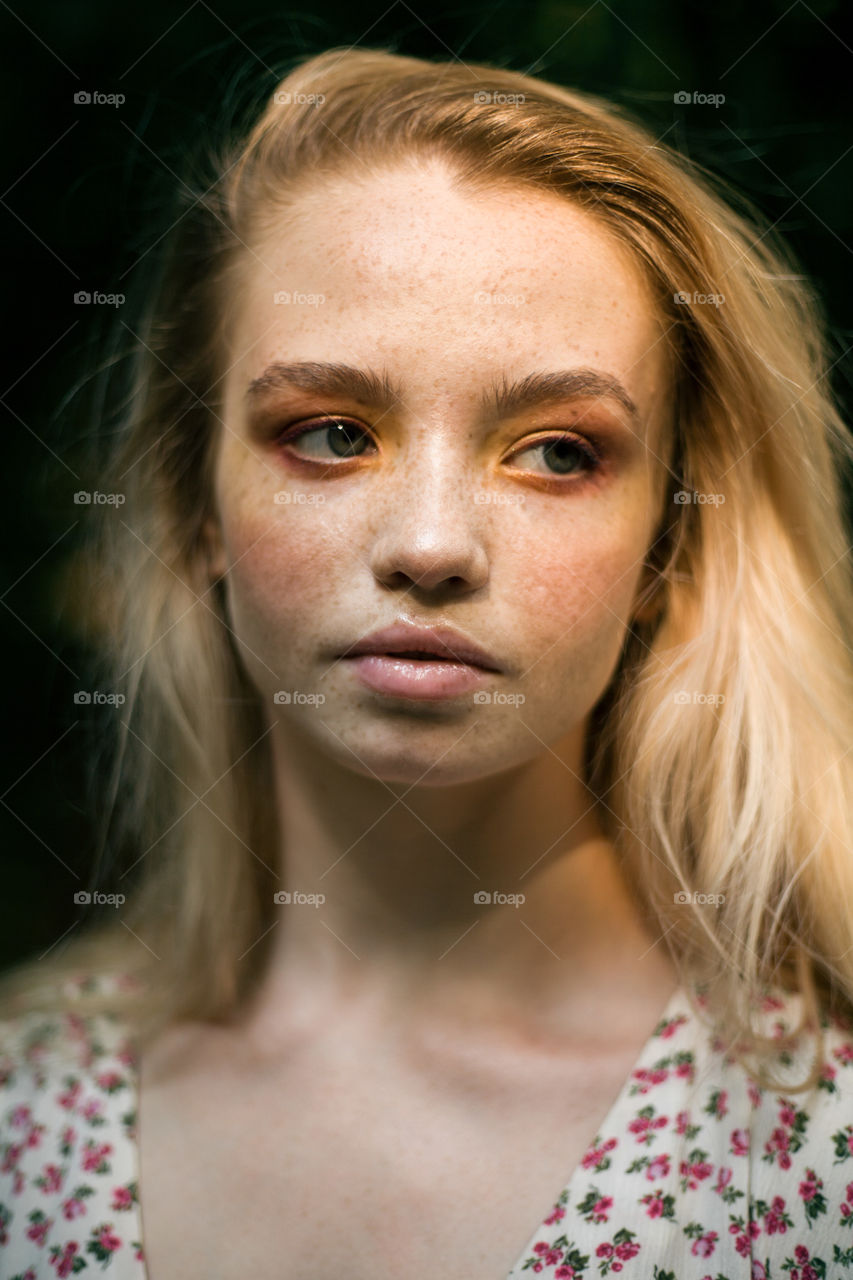 portrait photo of a young woman with bright makeup