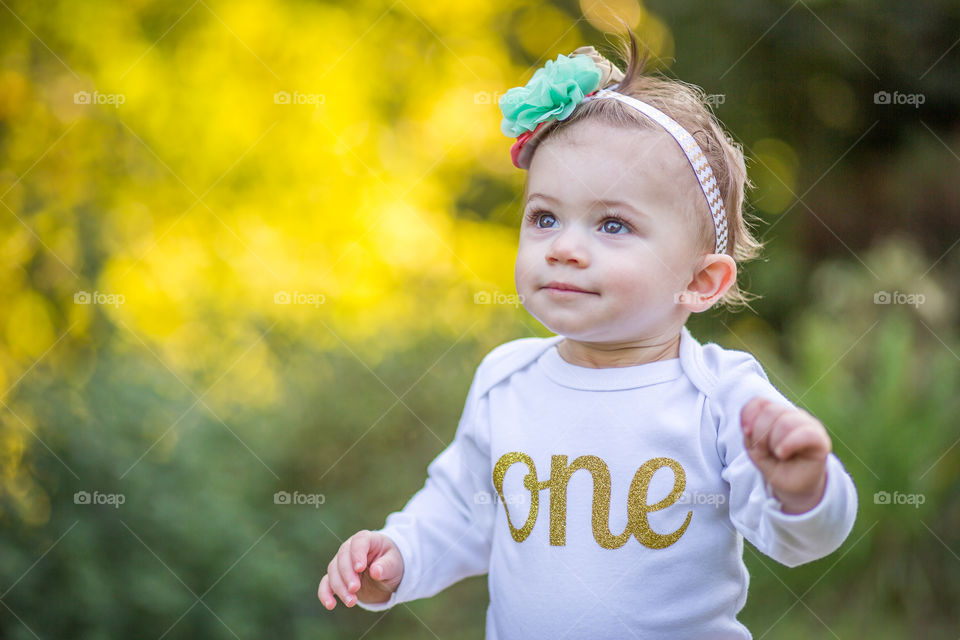 Beautiful cute baby girl with golden one text on top