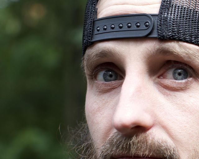 Man outdoors with a backwards hat