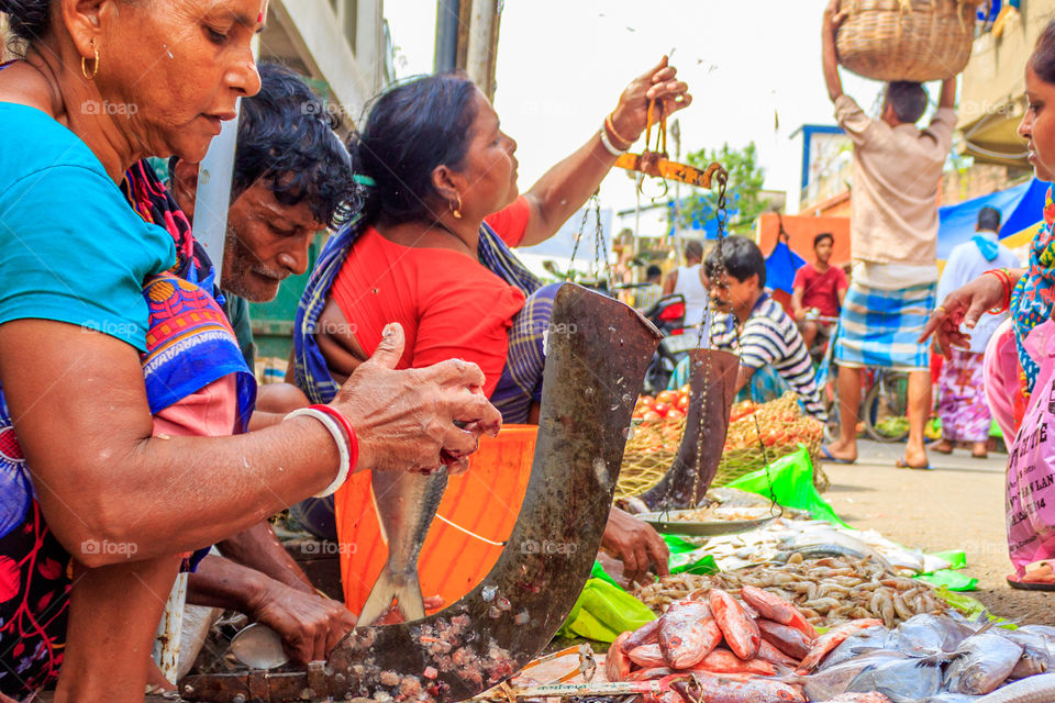 KOLKATA, INDIA - OCTOBER 05, 2018: Unknown people selling fish at a street market on OCTOBER 05, 2018 in the Koley Market area of Kolkata, West Bengal, India, Asia