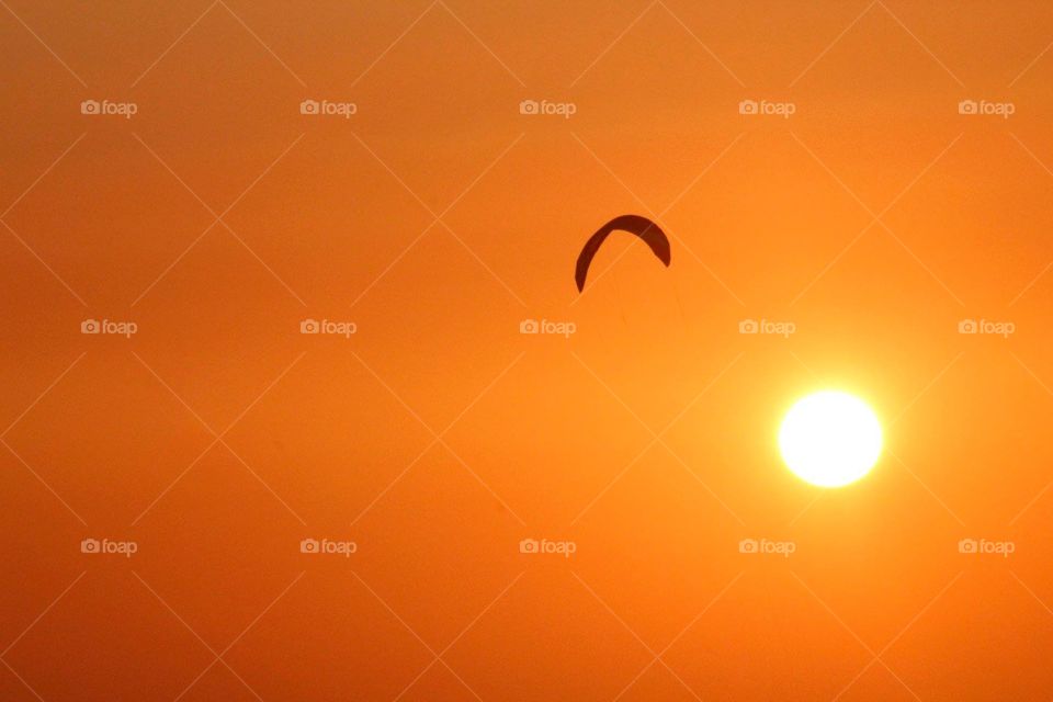 The beautiful orange and golden sunset. Playing around the parachute when it's going to the sea for a good night sleep. 