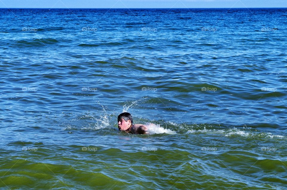 Man swimming in sea