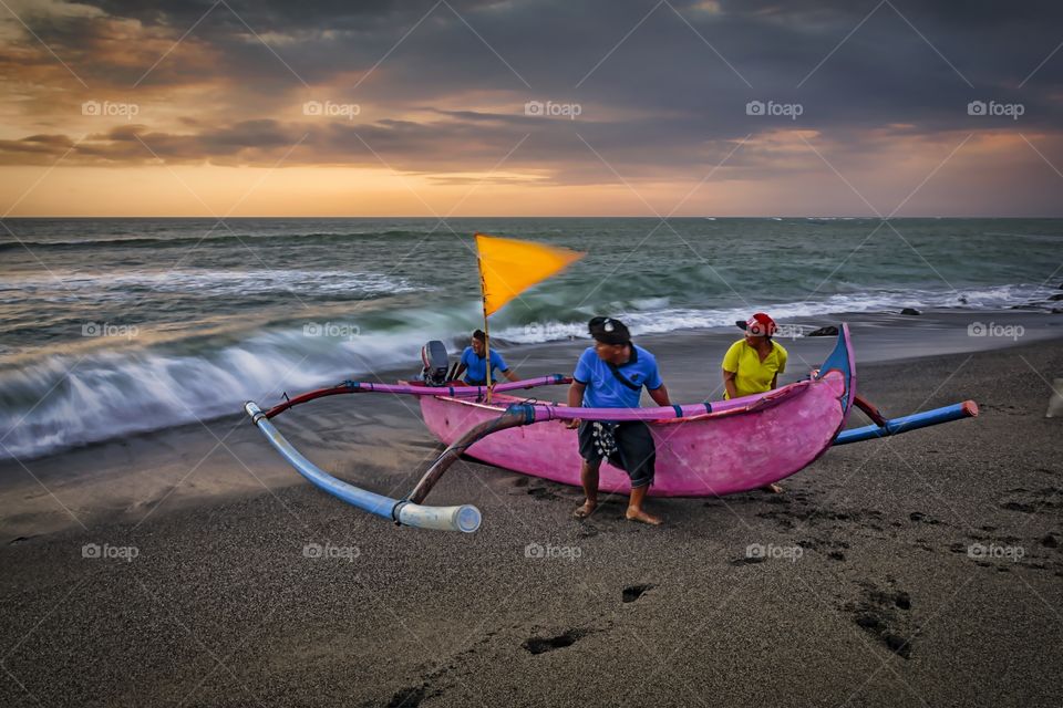 fisherman and wooden boat called jukung