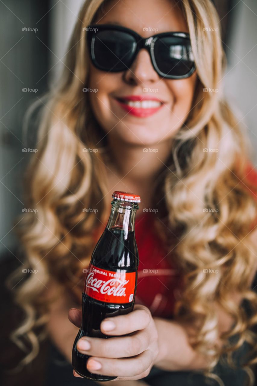 Girl holding a Coca Cola bottle