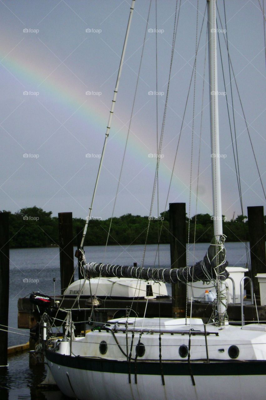 rainbow's end. rainbow over sailboat