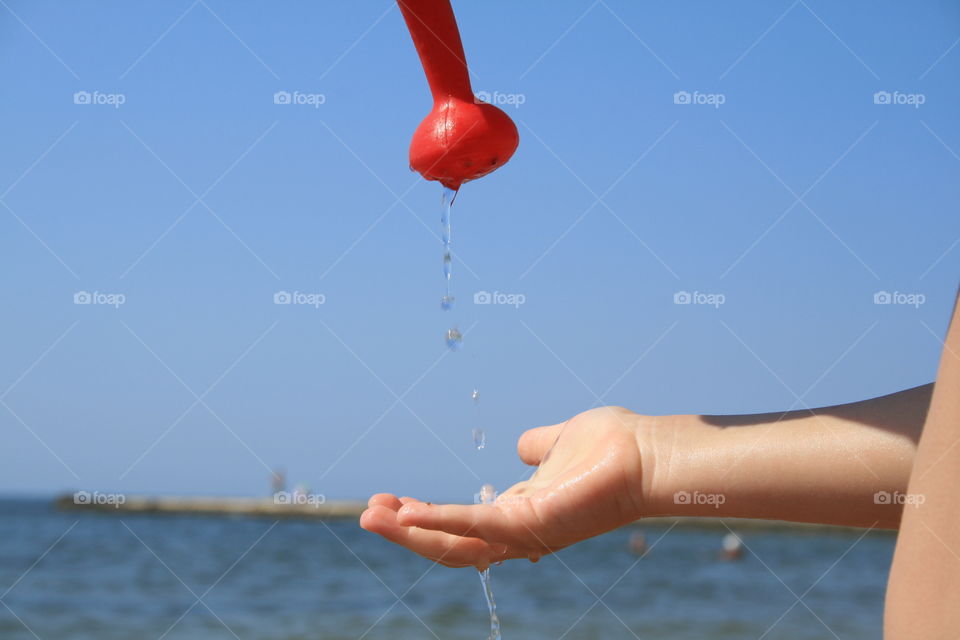 Drops of water and child's hand  