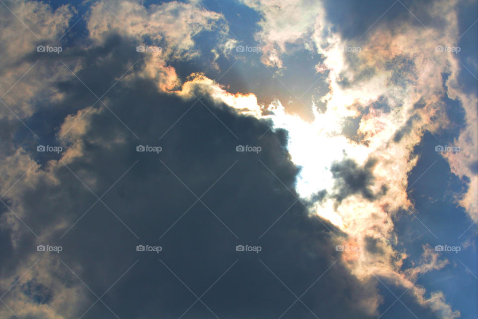 sun behind cloud