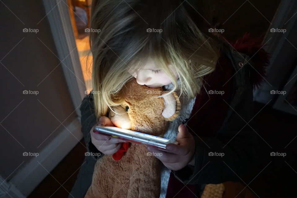 Caucasian girl holding smartphone