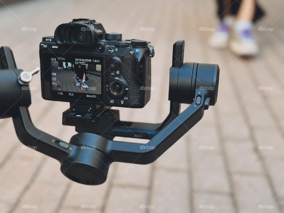 videographer taking a video with a camera and tripod