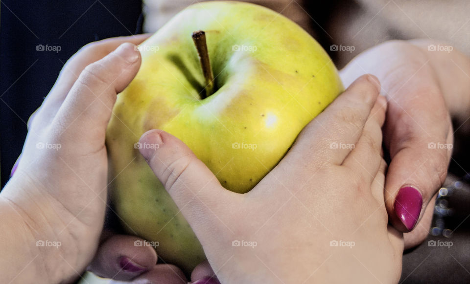 Mother with a small child holding an apple