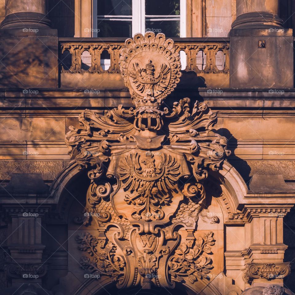 a beautiful cartouche on the facade of a tenement house