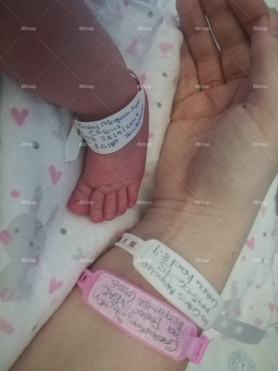 Hospital baby foot and mother's hand