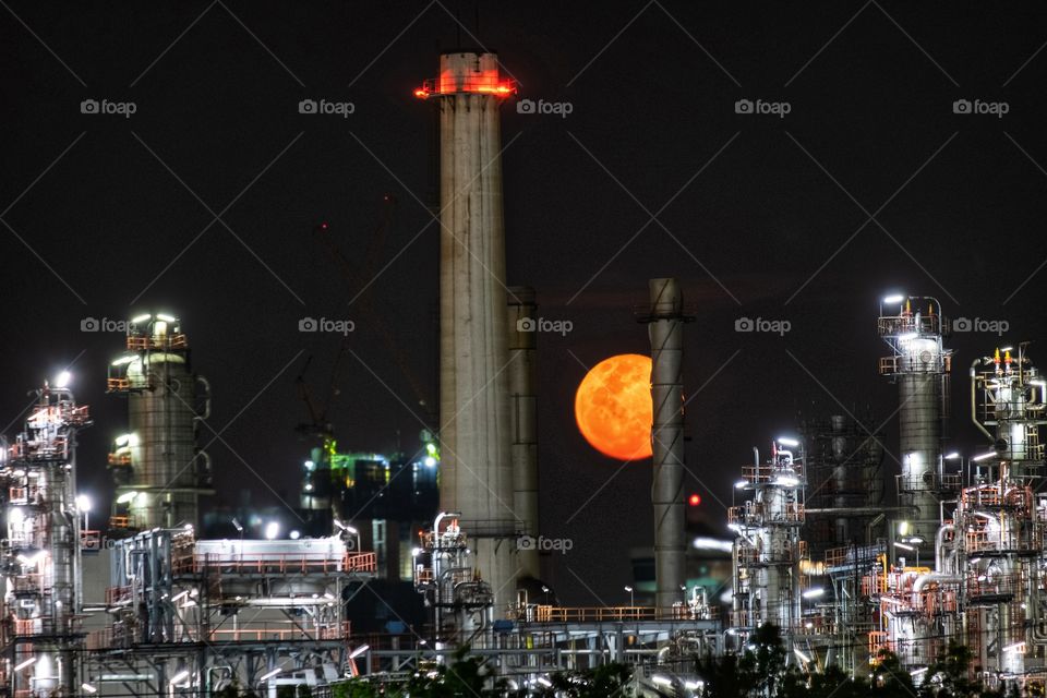Full moon behide oil refinery plant