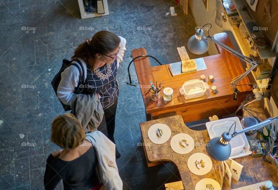 High angle view of two woman looking at equipments