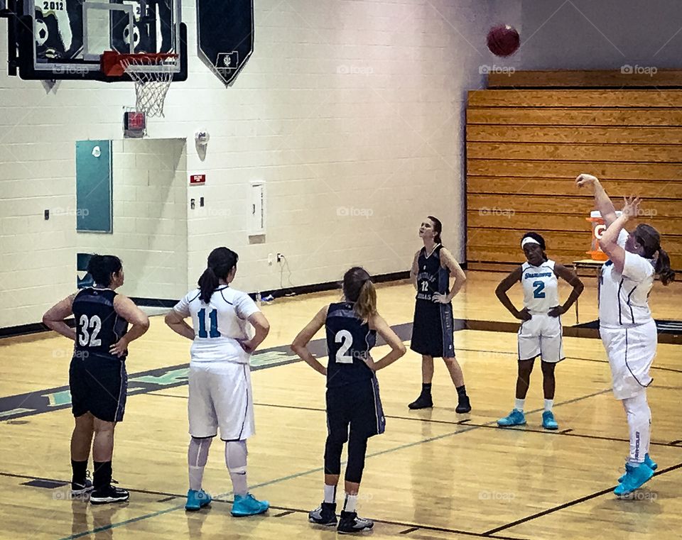 My sister playing at her high school on her basketball team.