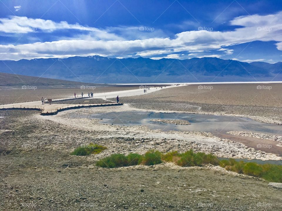 Tourists explore the expansive salt flats on a hot, sunny day in Nevada