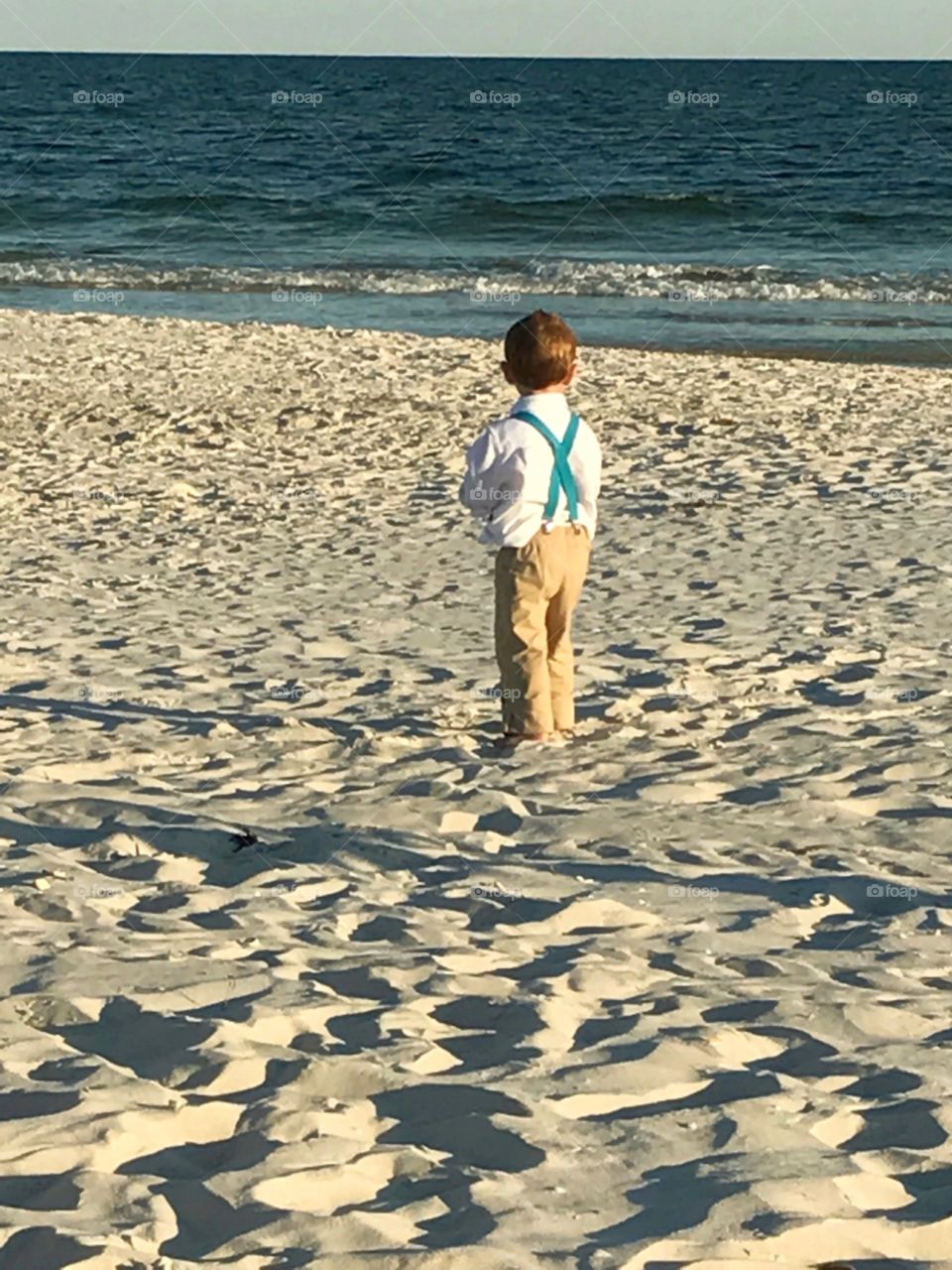 boy looking out into the ocean
