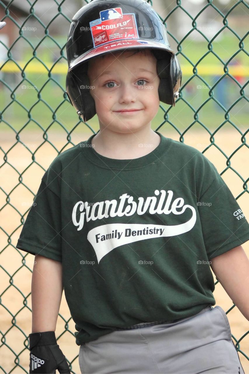 Next up to bat, my sweet little T-ball player is protecting his head with a batting helmet. 