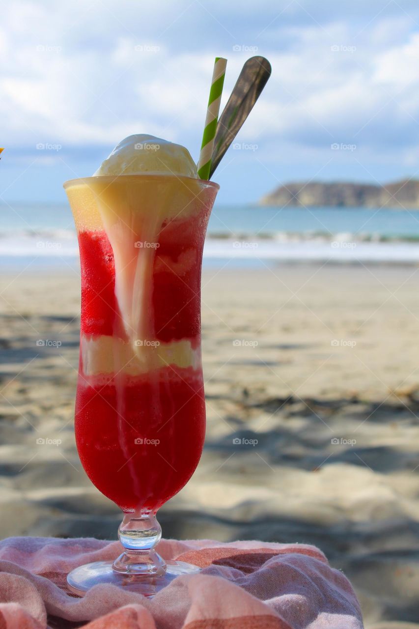 Cocktail with exotic fruits and ice cream in the shade of a beautiful beach in Costa Rica