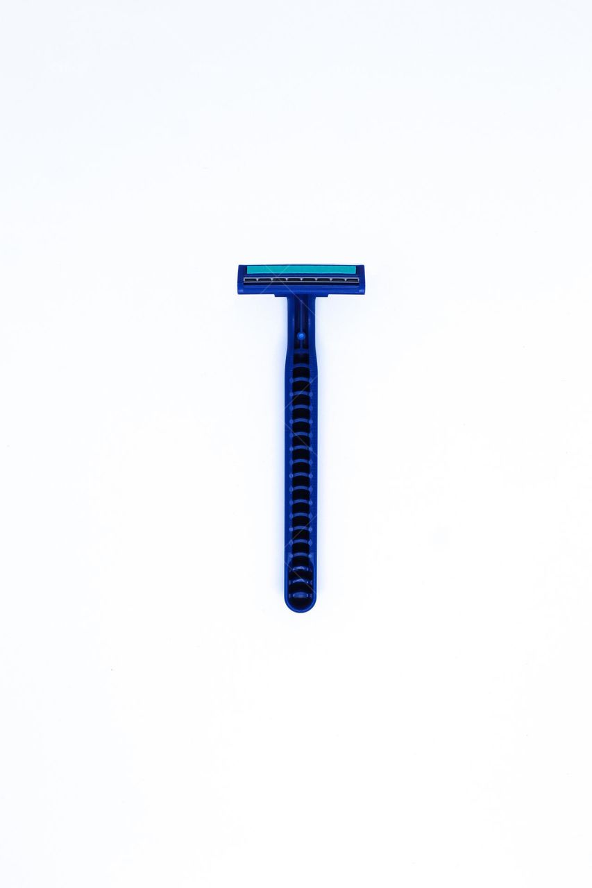 A Bottom of Blue Razor with Flat Lay Shot in The Minimalist White Background, Portrait Mode