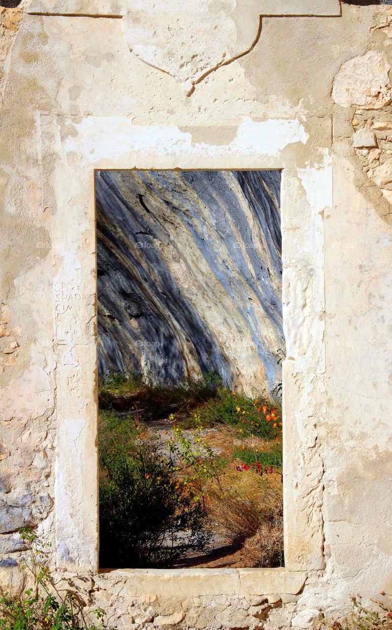 open Gate to stone wall and rock