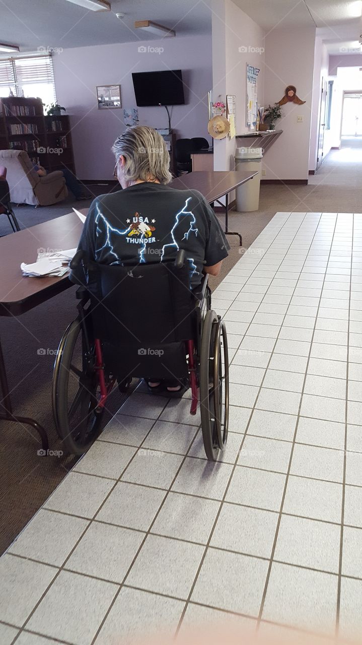 elder man in a wheelchair going through his mail