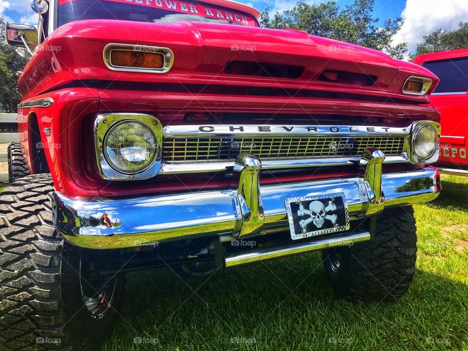 Front end of a refurbished classic red Chevrolet pick up truck